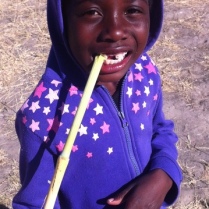 Julia enjoying some sugar cane
