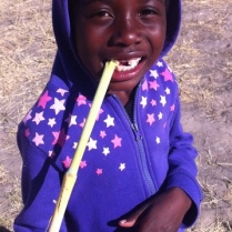 Julia enjoying some sugar cane