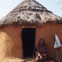 Himba lady in front of her hut